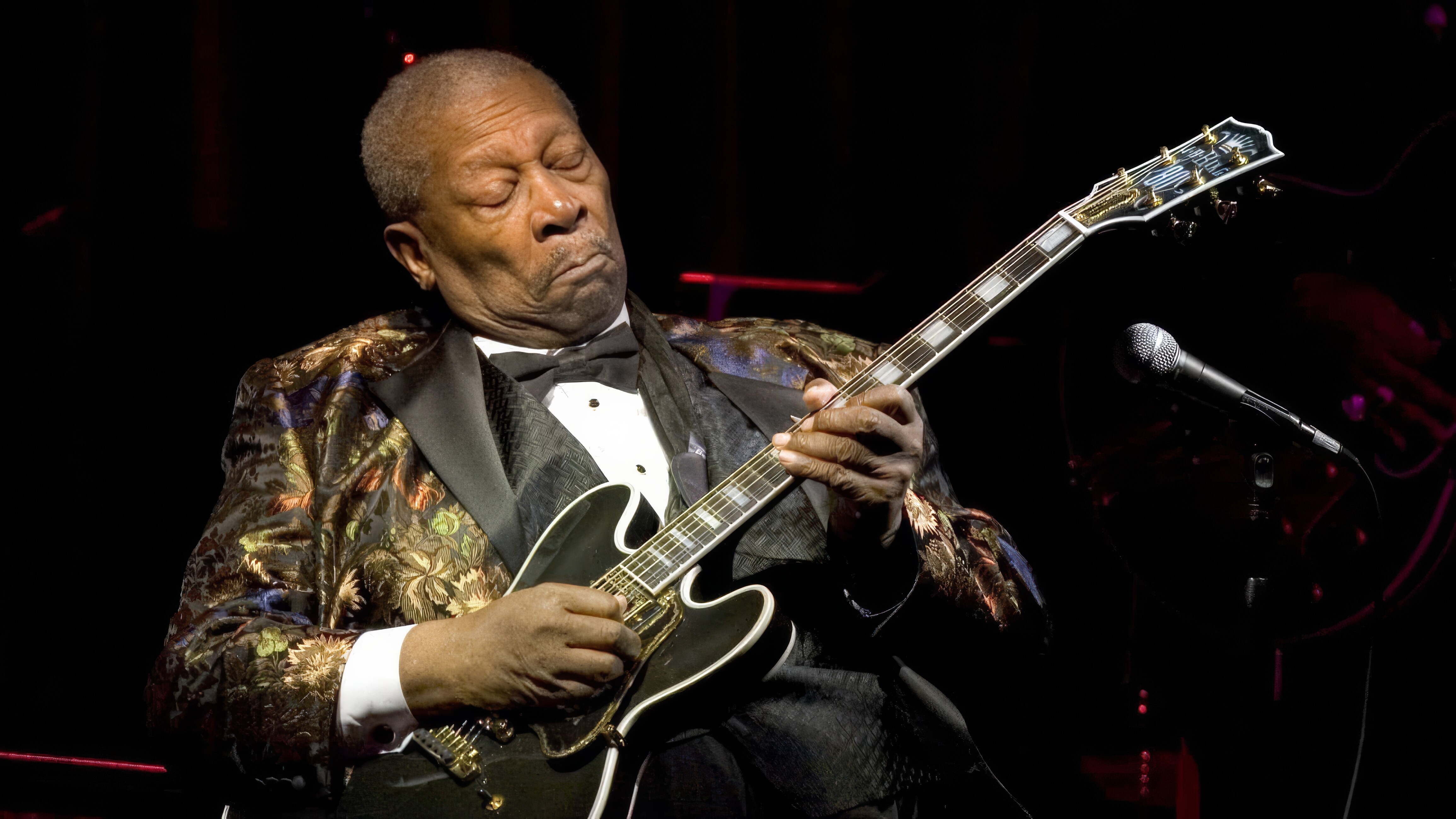 Blues guitarists playing a solo on stage