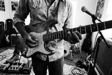 guitarist playing pinch harmonics