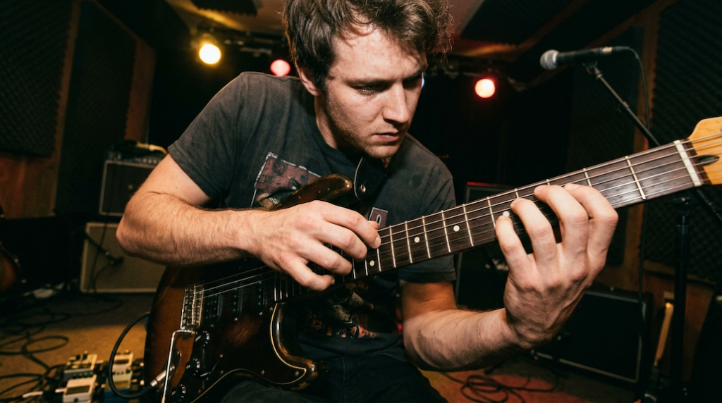 guitarist using tapping technique