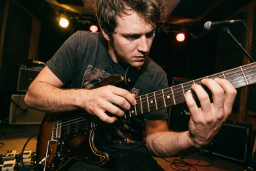 guitarist using tapping technique